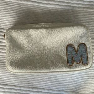 Small white Stoney Clover Lane pouch w/ light blue + pink floral M patch.